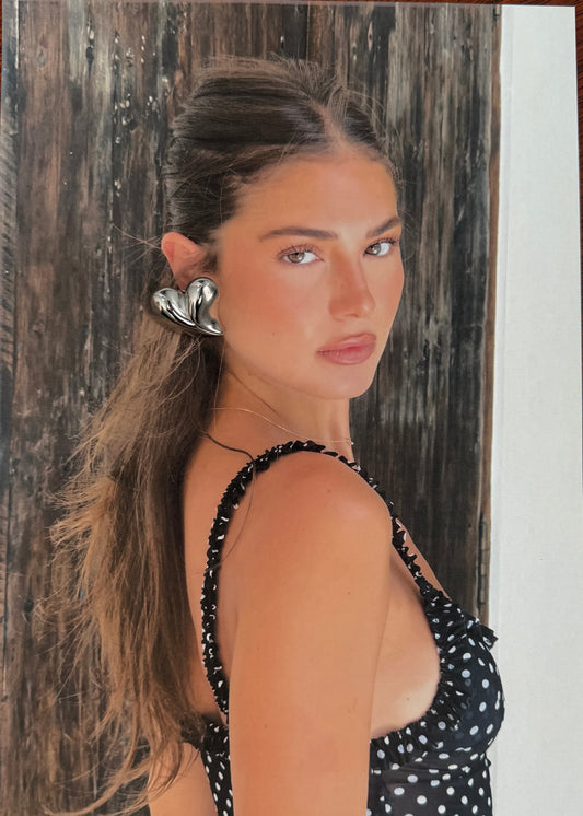 Wooden surface with a photo of a woman in a polka dot top