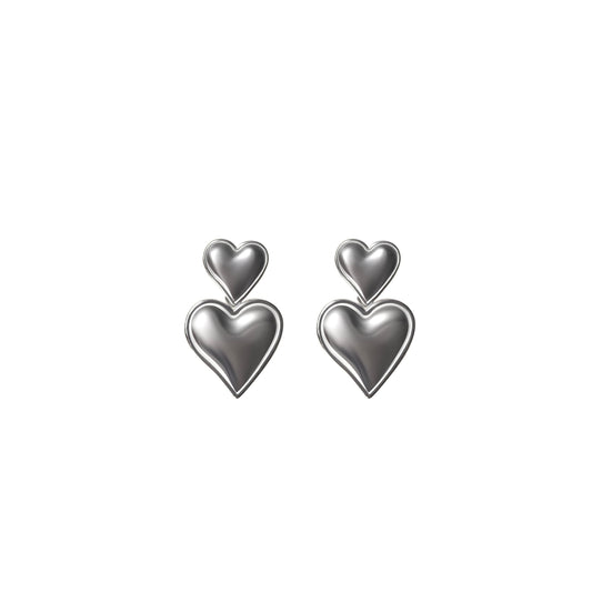 Pair of silver heart-shaped earrings on a white background