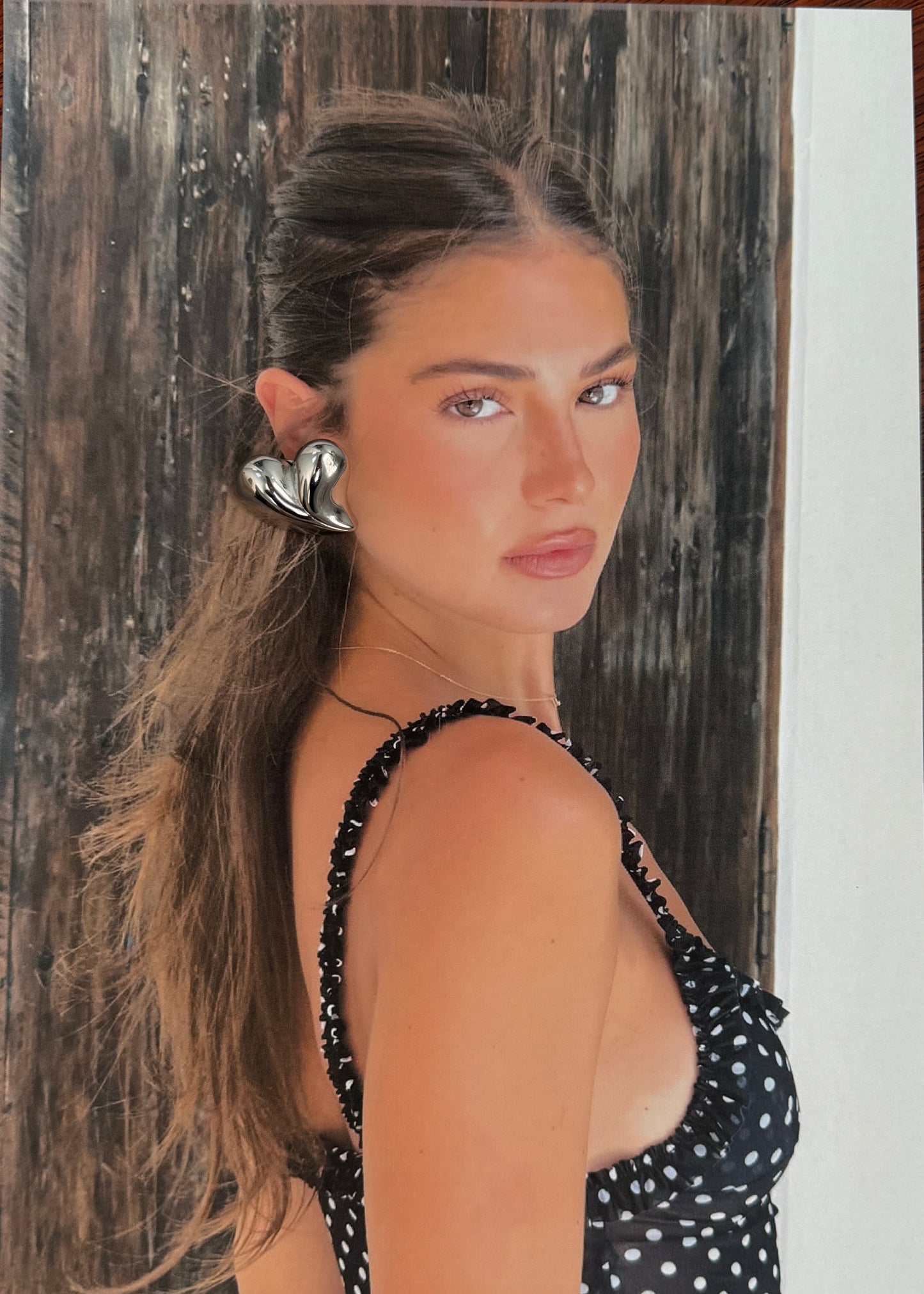 Wooden surface with a photo of a woman in a polka dot top